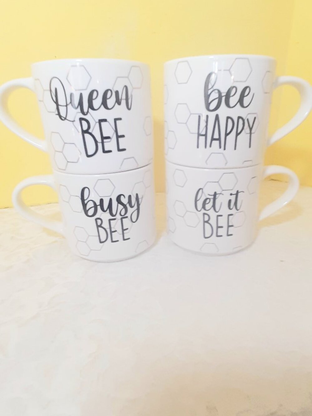 Set of 4 Bee themed stackable coffee mugs.